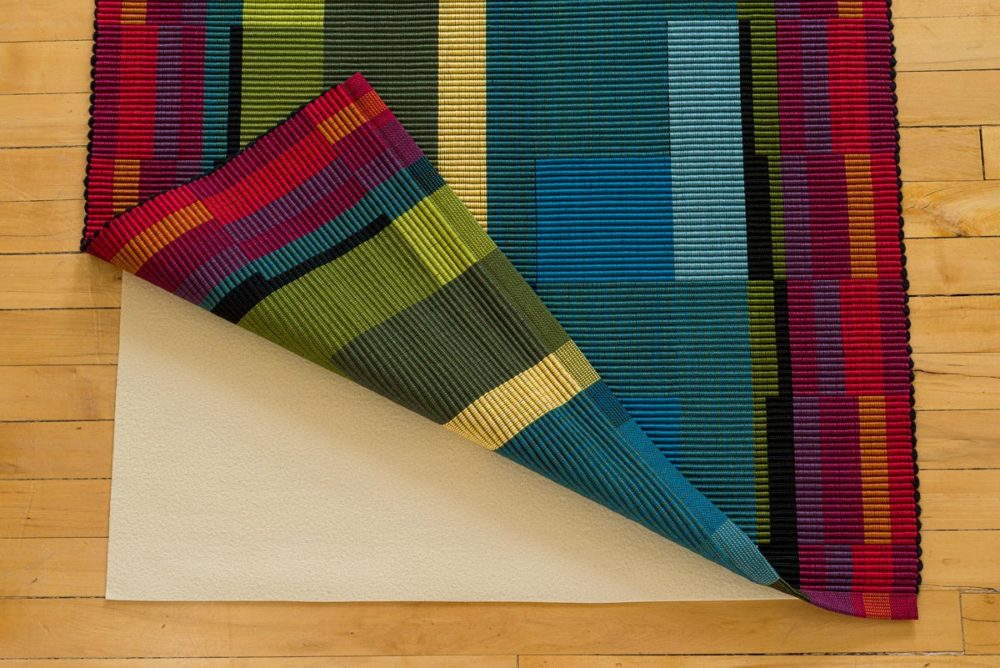 non-skid pad under rug by Kelly Marshall Custom Woven Interiors